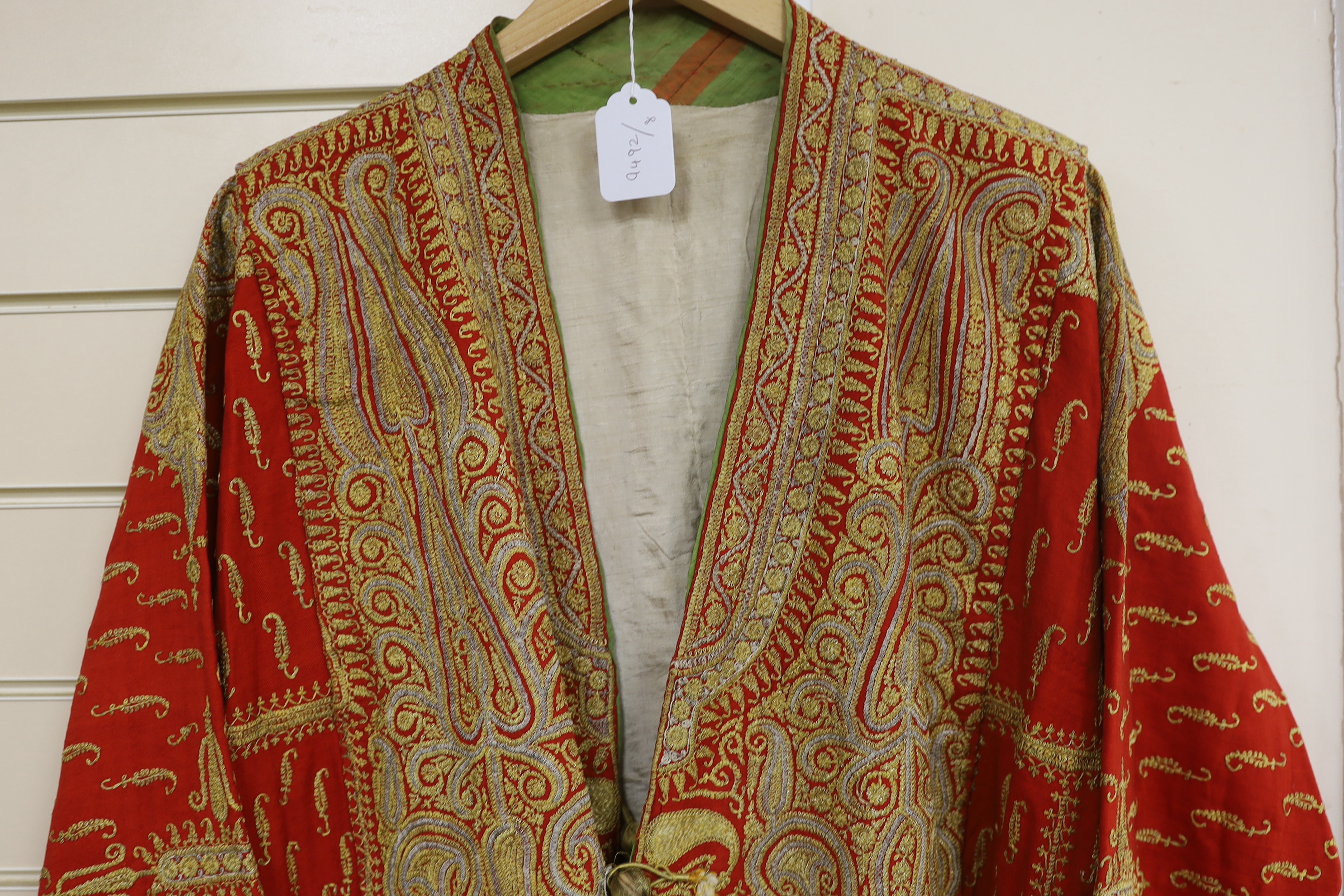 A 19th century fine wool coat, embroidered with gold and silver coloured metal threads in an all over paisley design